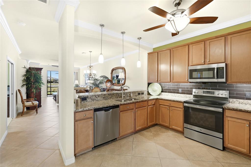 20209 Benissimo Drive Venice, FL 34293 - Photo 4 of 53 a kitchen with a sink stainless steel appliances and cabinets
