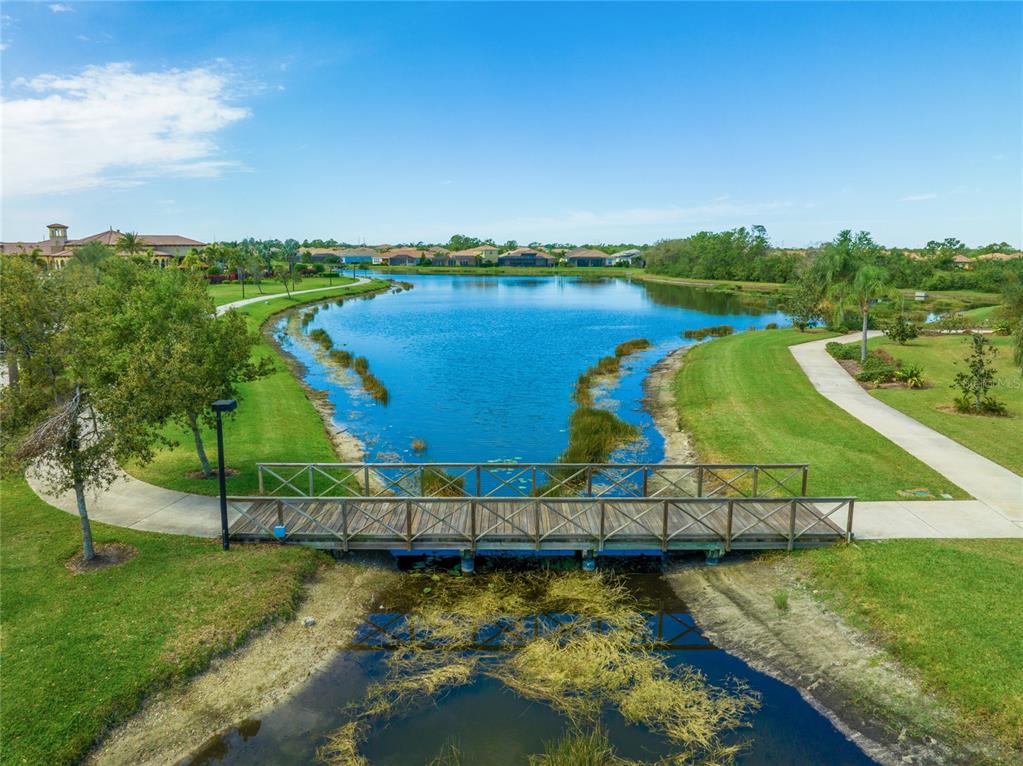 20209 Benissimo Drive Venice, FL 34293 - Photo 43 of 53 an aerial view of a house with a garden and lake view