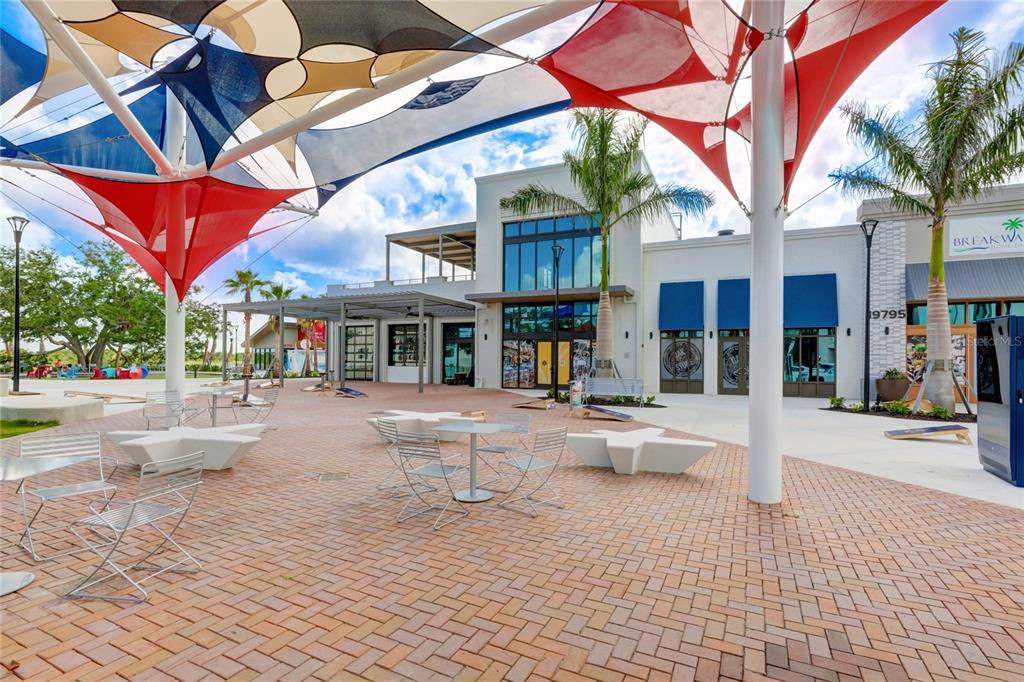 20209 Benissimo Drive Venice, FL 34293 - Photo 46 of 53 a view of a patio with a table and chairs under an umbrella