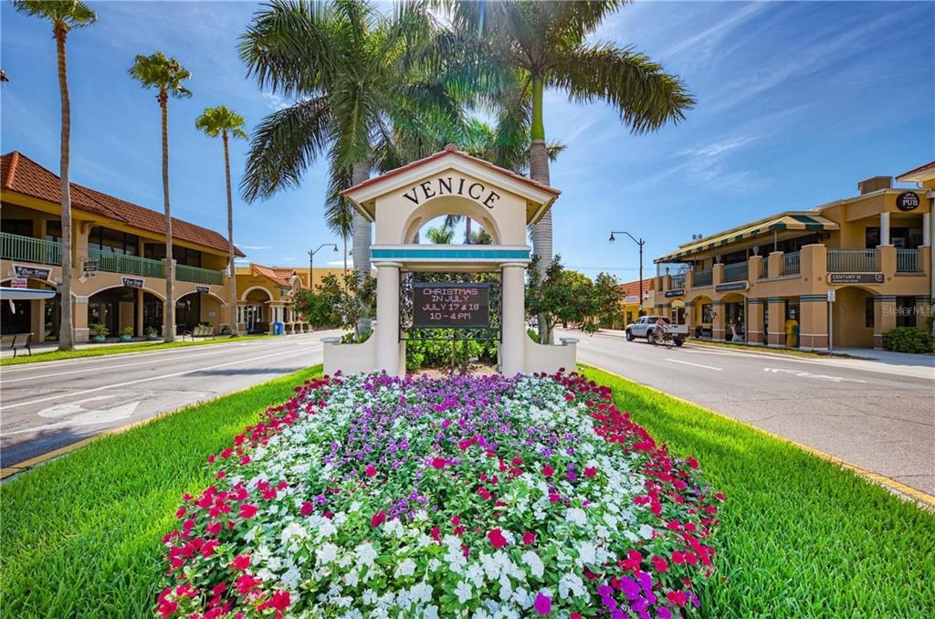 20209 Benissimo Drive Venice, FL 34293 - Photo 51 of 53 a front view of multi story residential apartment building with yard and sign board