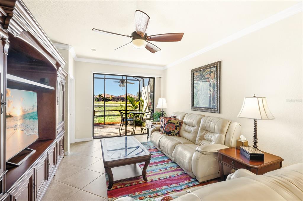 20209 Benissimo Drive Venice, FL 34293 - Photo 9 of 53 a living room with furniture and a flat screen tv
