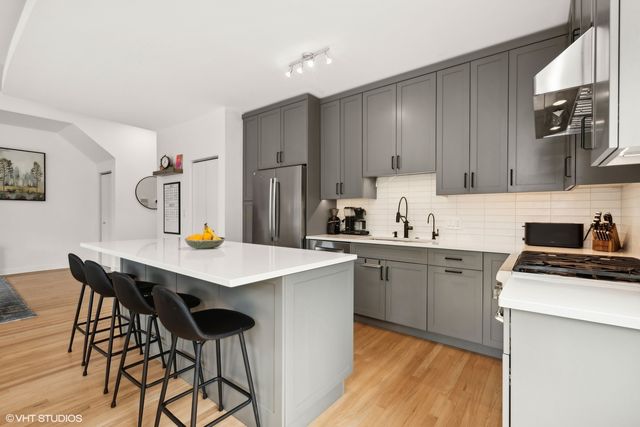 a kitchen with a sink a stove a refrigerator and cabinets