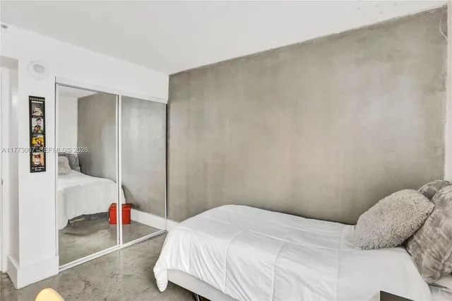 a bedroom with a bed and walk in closet