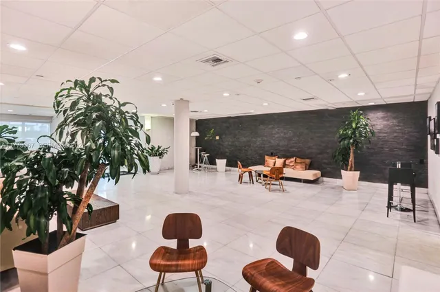 a outdoor space with lots of chairs a projector and a table