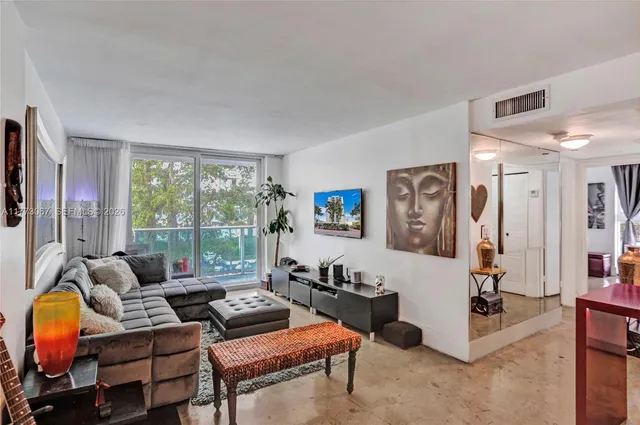 a living room with furniture and a floor to ceiling window