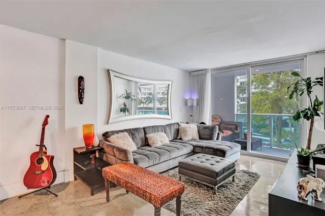 a living room with furniture and a large window