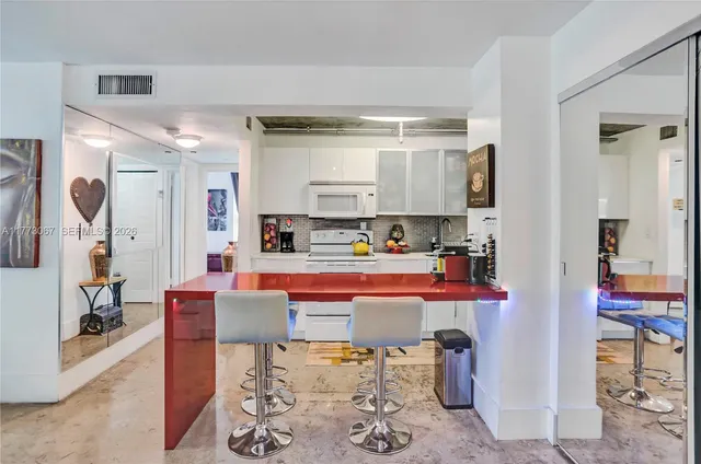 a living room with stainless steel appliances kitchen island granite countertop furniture and a view of kitchen