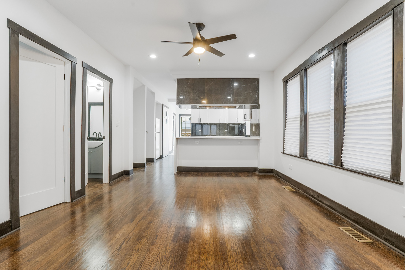 5526 South Albany Avenue Chicago, IL 60629 - Photo 4 of 25 a view of a livingroom with wooden floor and a ceiling fan