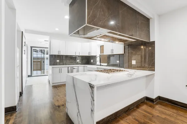 a view of kitchen with cabinets and wooden floor