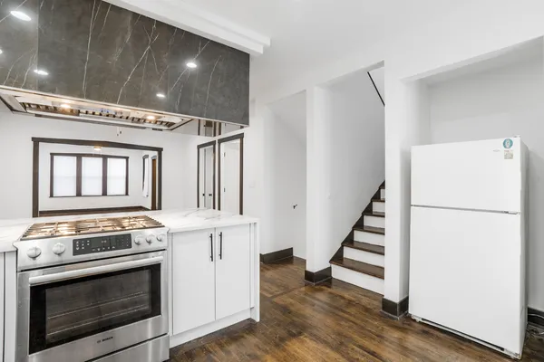 a kitchen with a stove oven and white cabinets