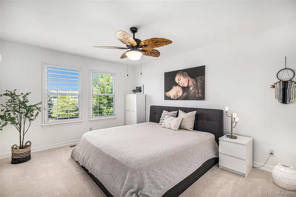 a bedroom with a bed and a potted plant