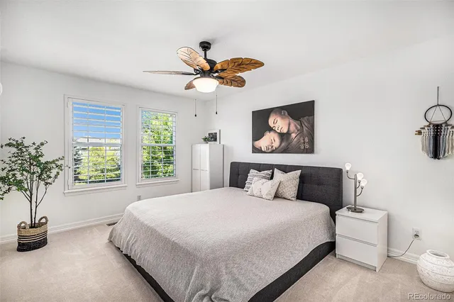 a bedroom with a bed and a potted plant