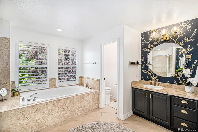 a spacious bathroom with double vanity and a mirror or bathtub