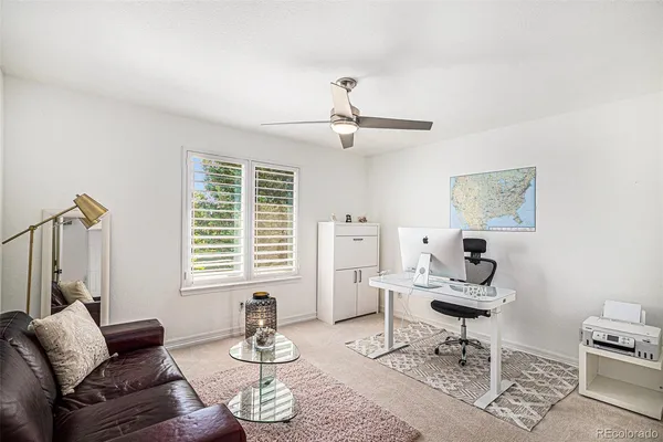 a living room with furniture a rug and a window