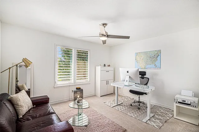 a living room with furniture a rug and a window