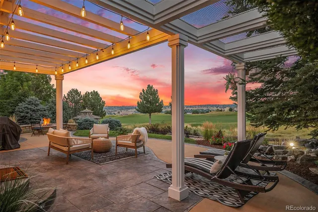 a view of a patio with a table chairs and a backyard