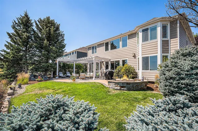 a front view of house with outdoor seating and yard