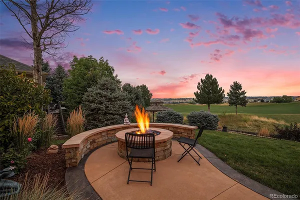 a backyard of a house with table and chairs