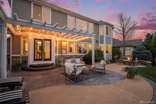 a view of a patio with table and chairs and potted plants