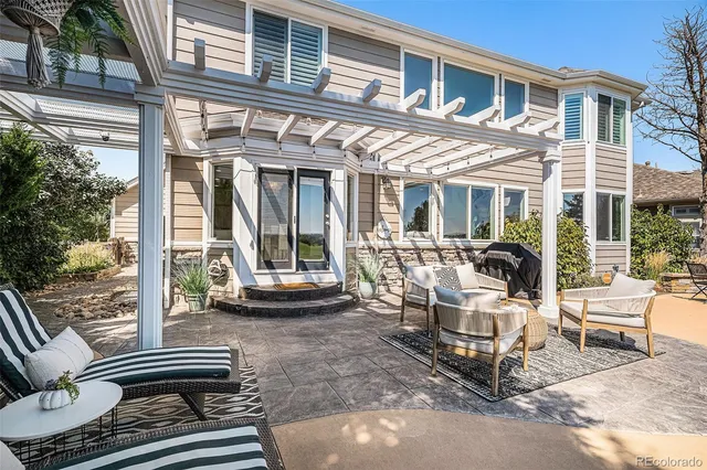 a view of a patio with a table and chairs