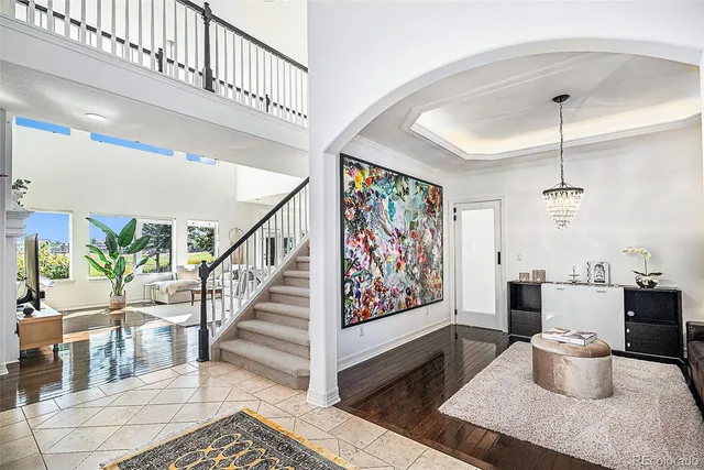 a view of a dining room with furniture a rug and wooden floor
