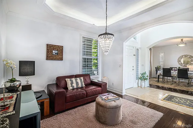 a living room with furniture and a chandelier