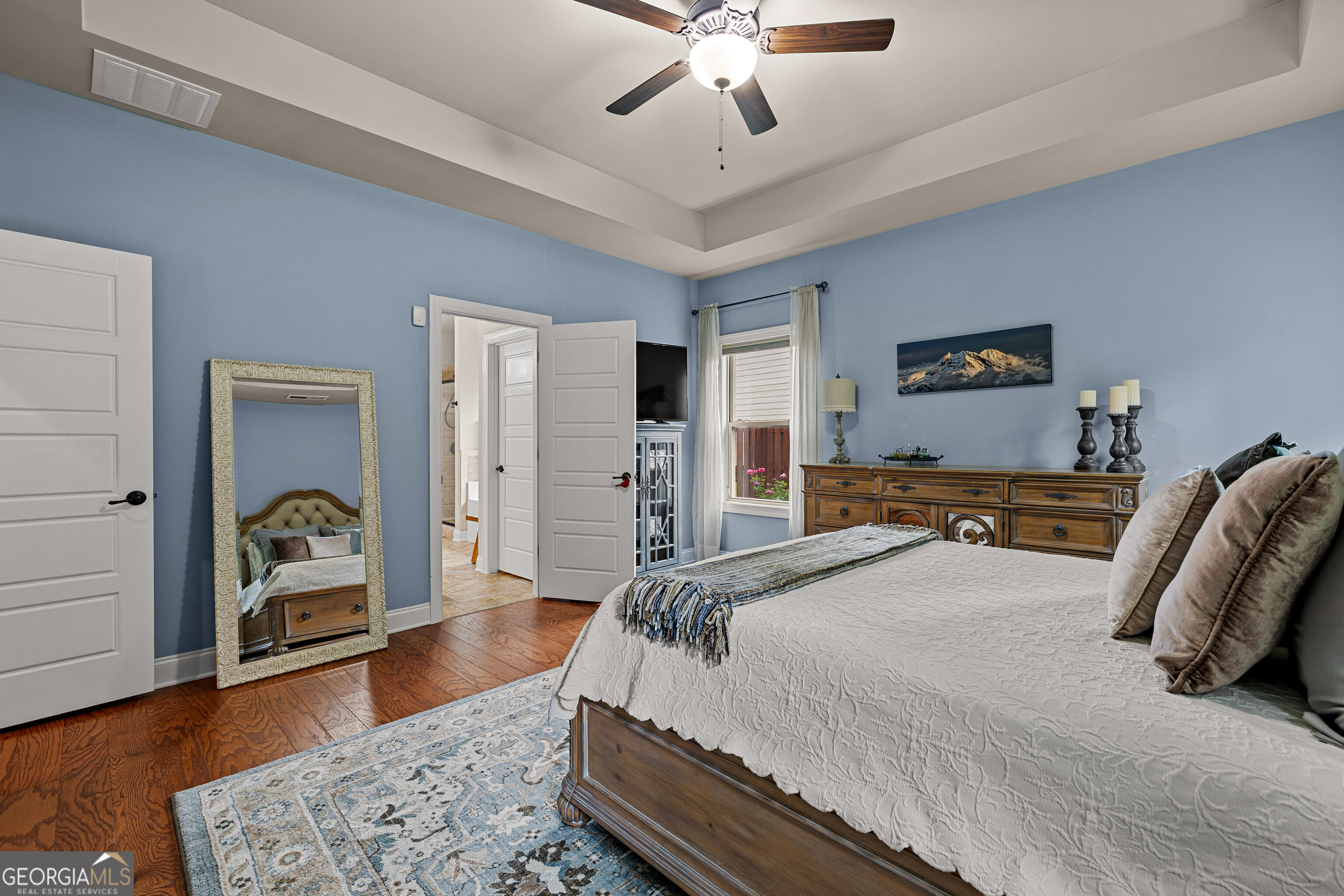 12 Delaware Way Newnan, GA 30265 - Photo 27 of 61 Primary bedroom with a wall-mounted TV and direct access to the en-suite bath.