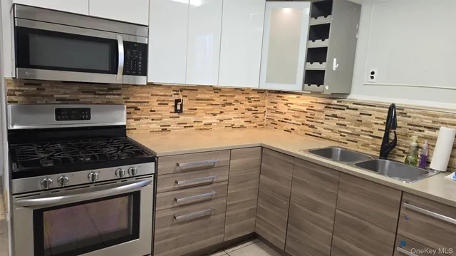 a kitchen with stainless steel appliances a stove and a microwave
