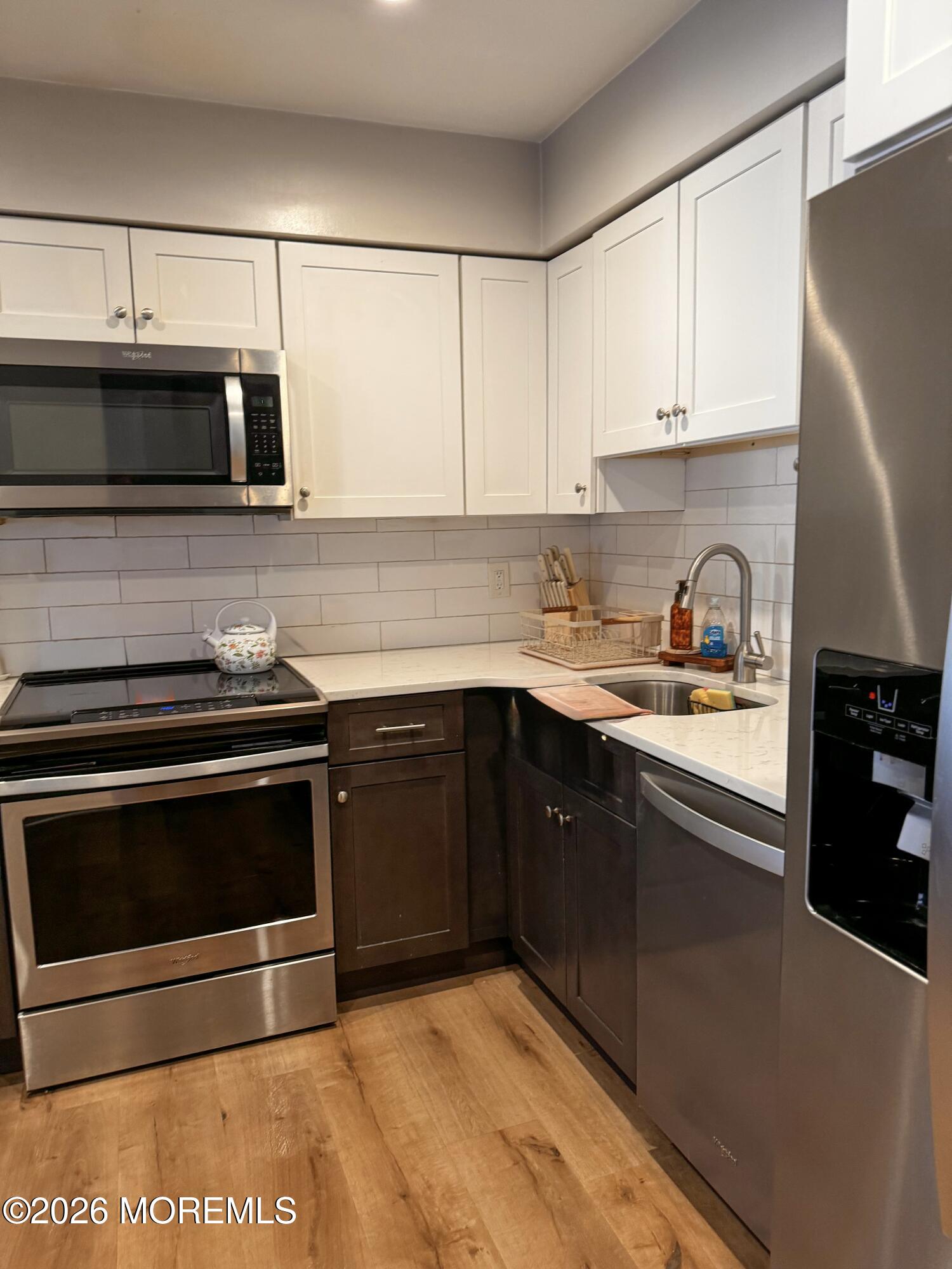 22 Alexandria Way Basking Ridge, NJ 07920 - Photo 14 of 31 a kitchen with stainless steel appliances granite countertop a stove a microwave and a refrigerator