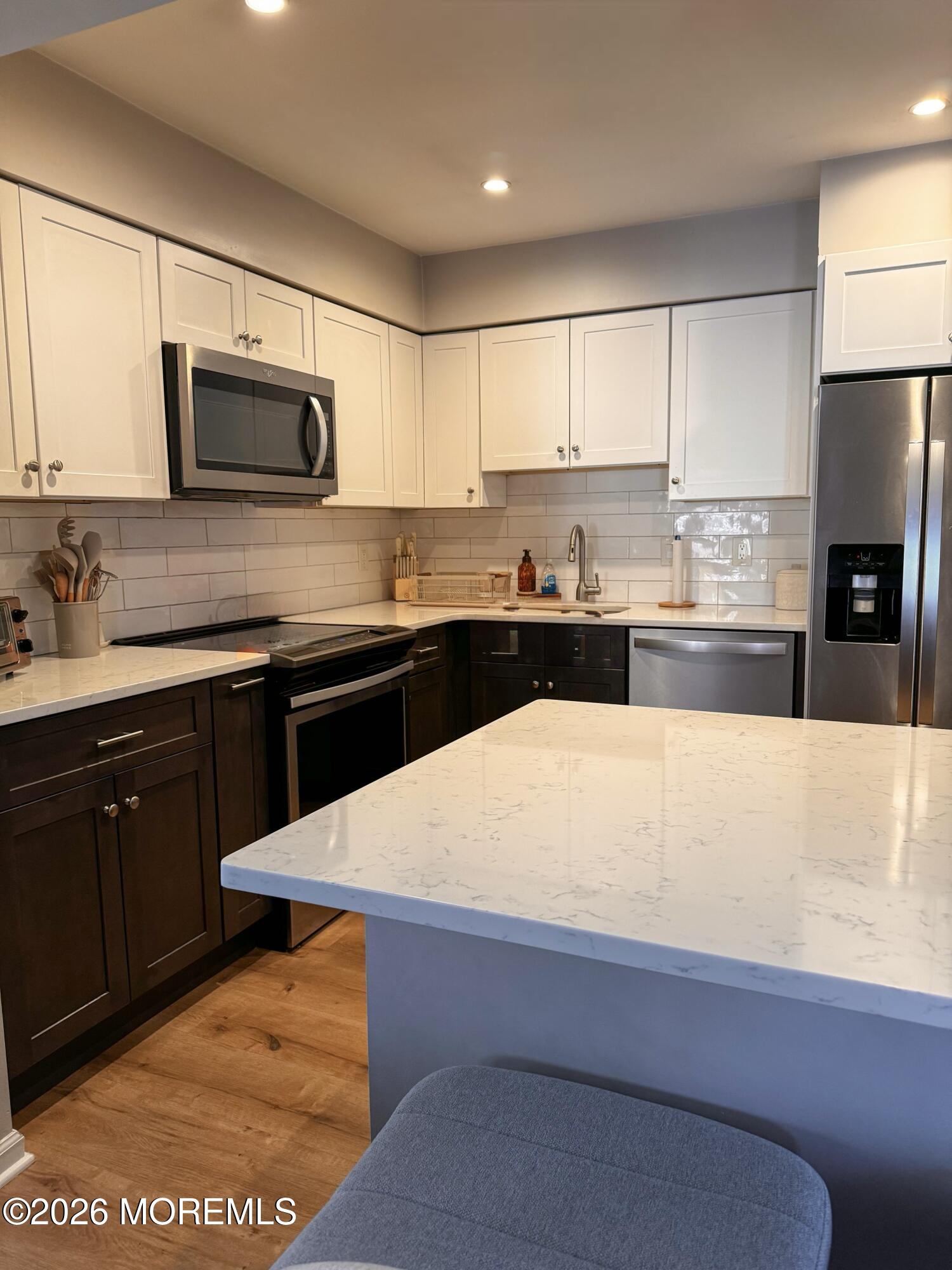 22 Alexandria Way Basking Ridge, NJ 07920 - Photo 15 of 31 a kitchen with stainless steel appliances kitchen island granite countertop a sink dishwasher stove top oven and refrigerator