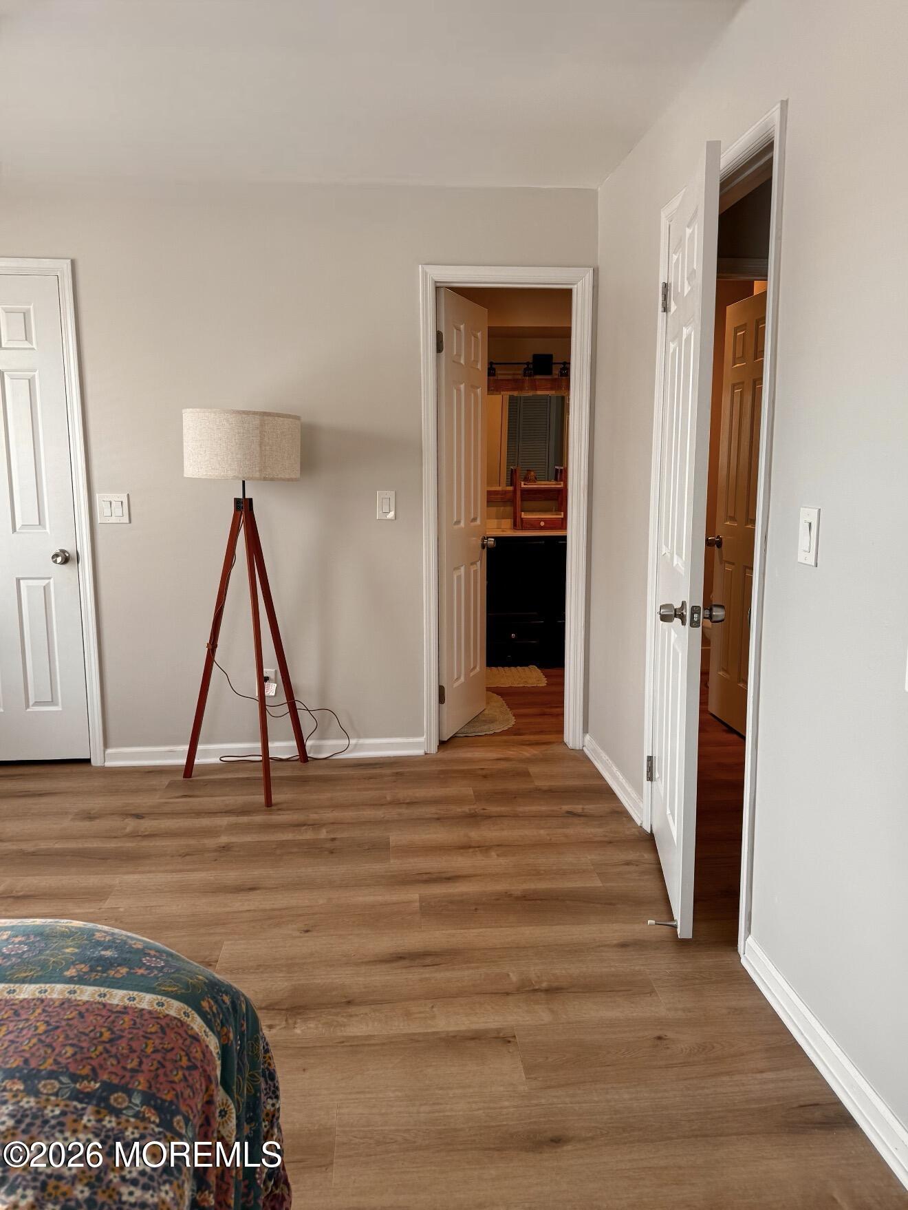 22 Alexandria Way Basking Ridge, NJ 07920 - Photo 24 of 31 a view of an empty room with wooden floor and a ceiling fan
