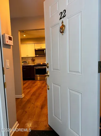 a large kitchen with stainless steel appliances granite countertop a stove top oven a sink dishwasher and a refrigerator