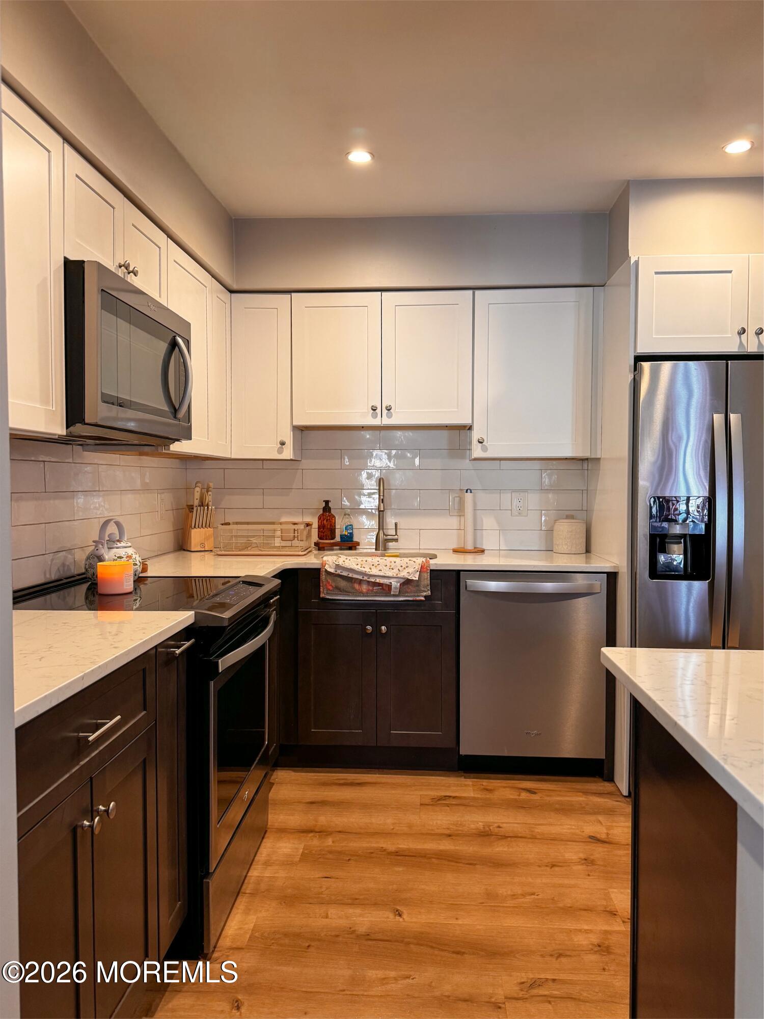 22 Alexandria Way Basking Ridge, NJ 07920 - Photo 7 of 31 a large kitchen with stainless steel appliances granite countertop a stove top oven a sink dishwasher and a refrigerator
