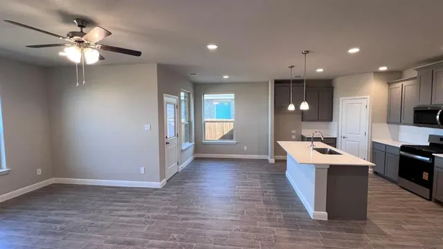 a kitchen with stainless steel appliances granite countertop a sink stove and refrigerator