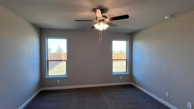 a large kitchen with a center island wooden floor stainless steel appliances and a window