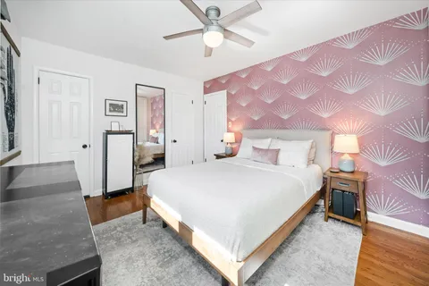 a spacious bedroom with a bed and a chandelier