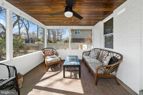 a balcony with furniture and a large window