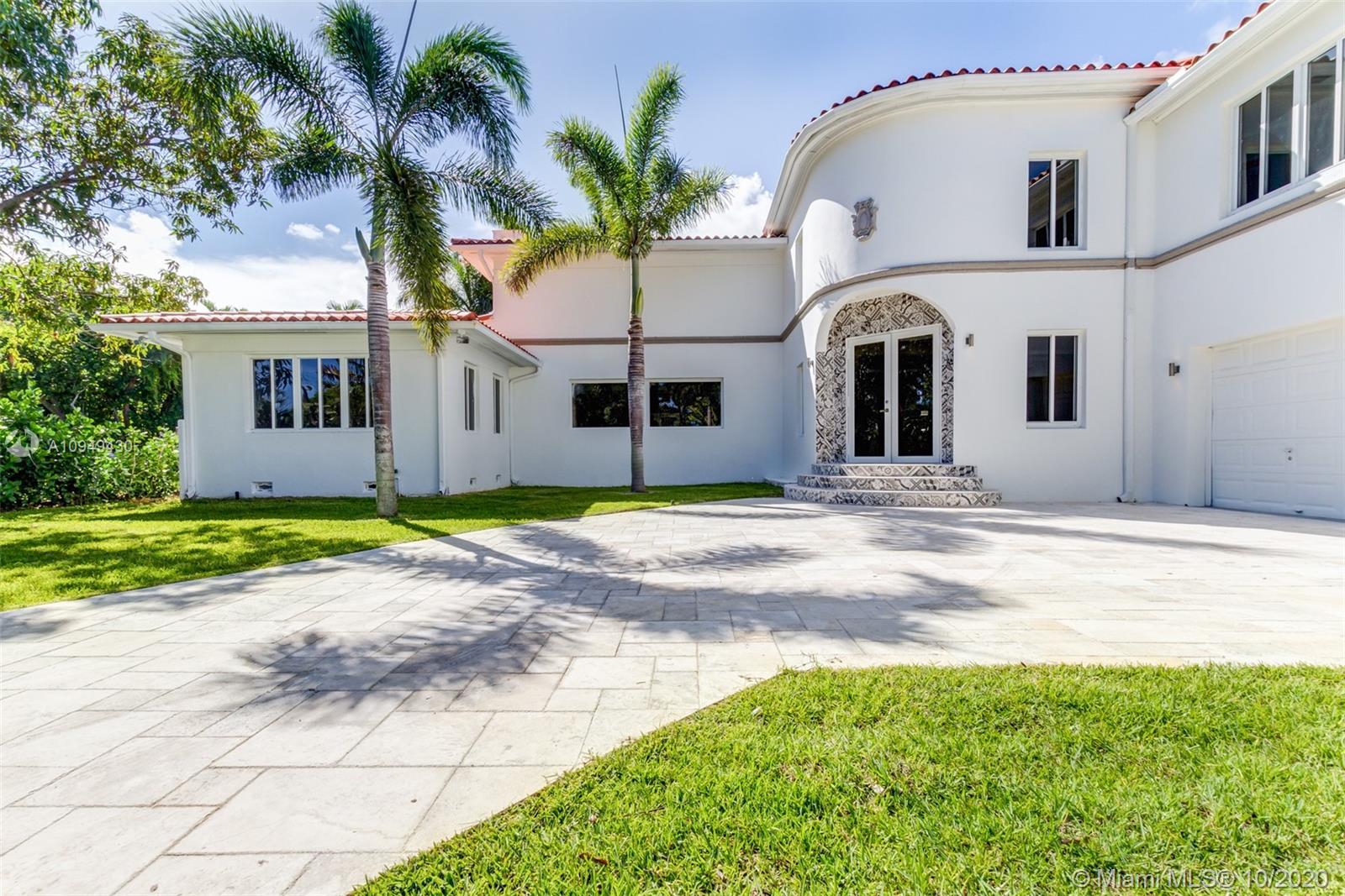 6030 Alton Road Miami Beach, FL 33140 - Photo 2 of 51 a front view of a house with a garden