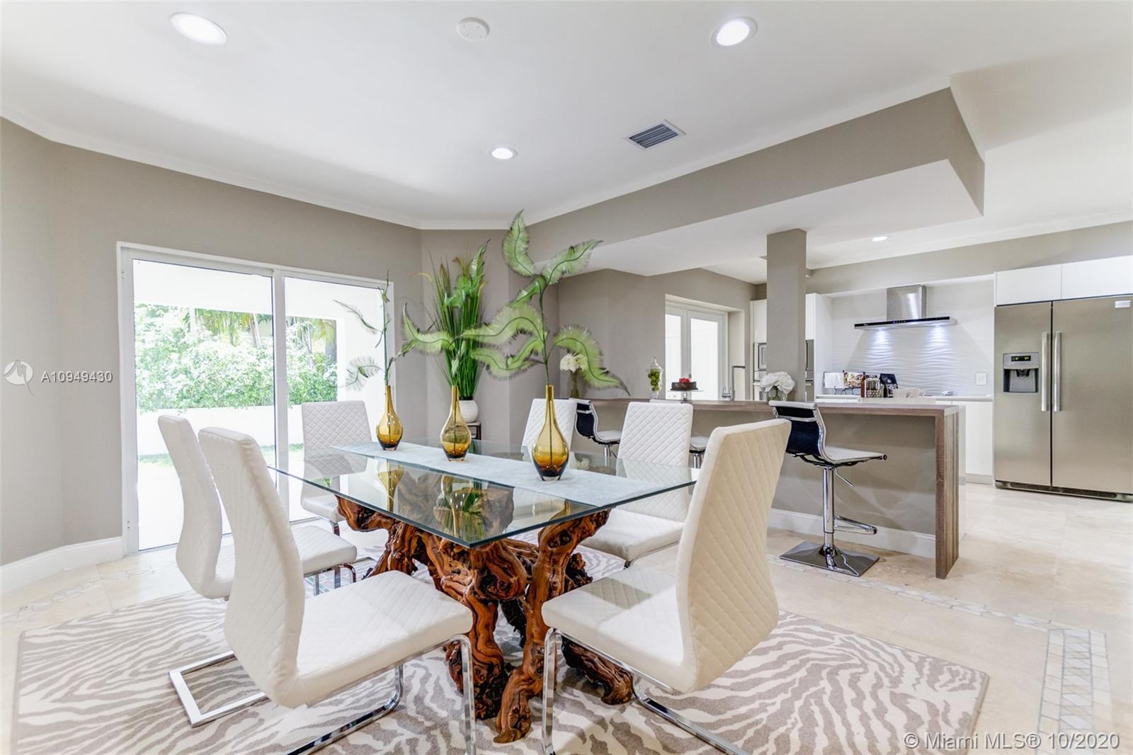 6030 Alton Road Miami Beach, FL 33140 - Photo 13 of 51 a view of a dining room with furniture window and outside view