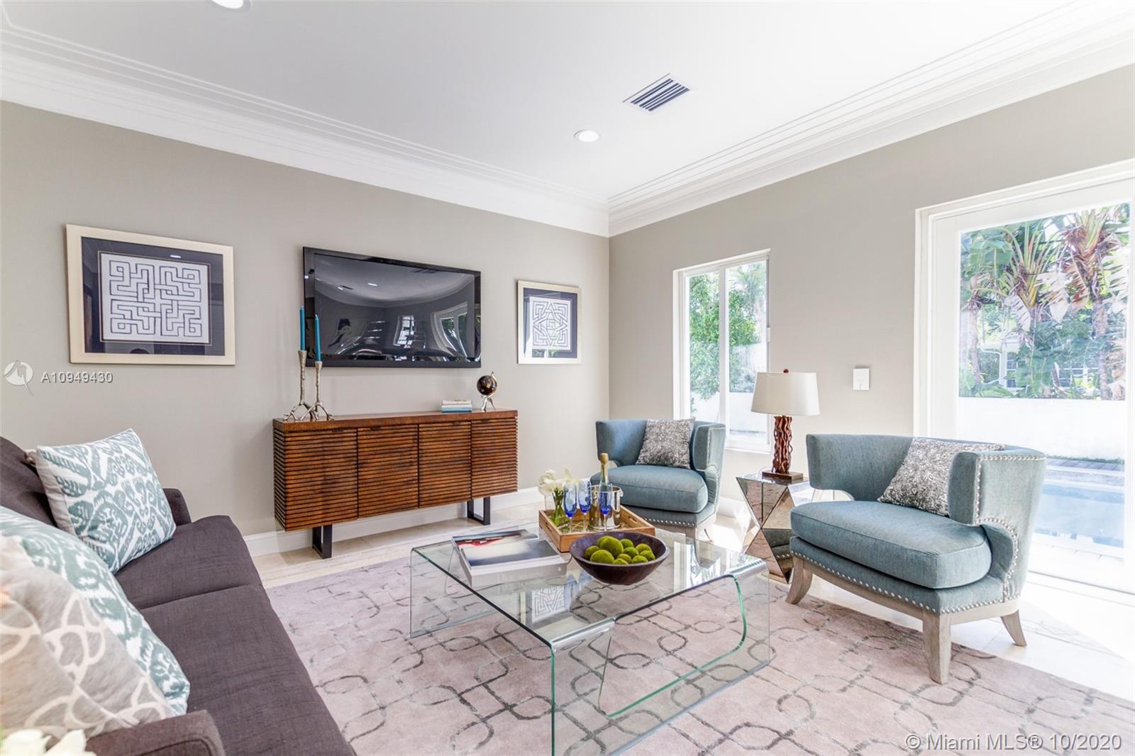 6030 Alton Road Miami Beach, FL 33140 - Photo 15 of 51 a living room with furniture and a fireplace