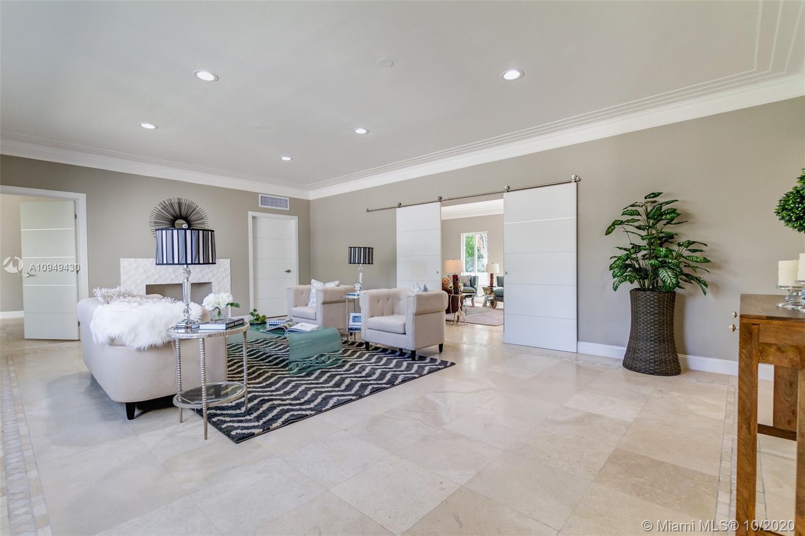 6030 Alton Road Miami Beach, FL 33140 - Photo 19 of 51 a living room with furniture and flowers