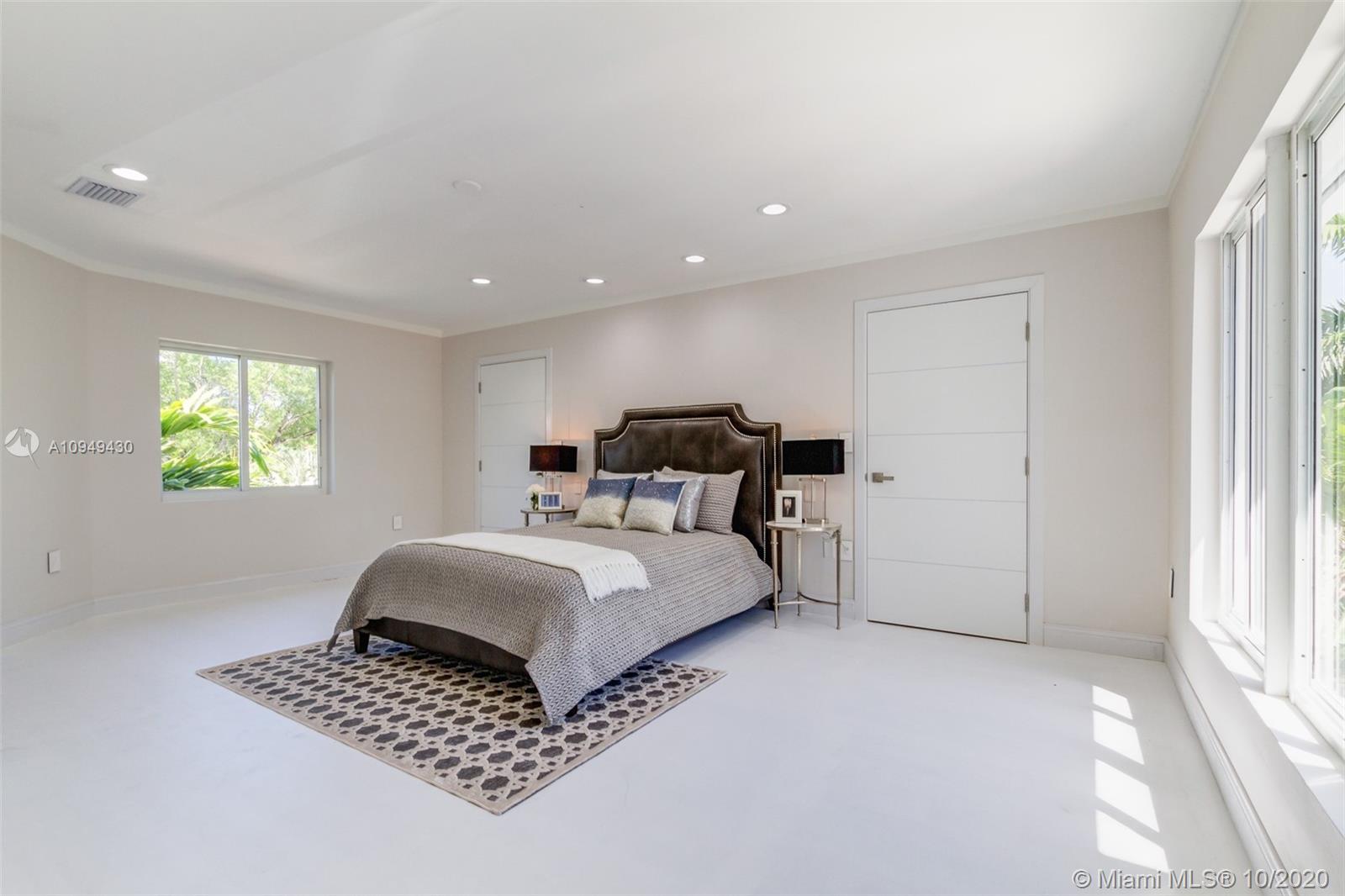 6030 Alton Road Miami Beach, FL 33140 - Photo 22 of 51 a bedroom with bed and window