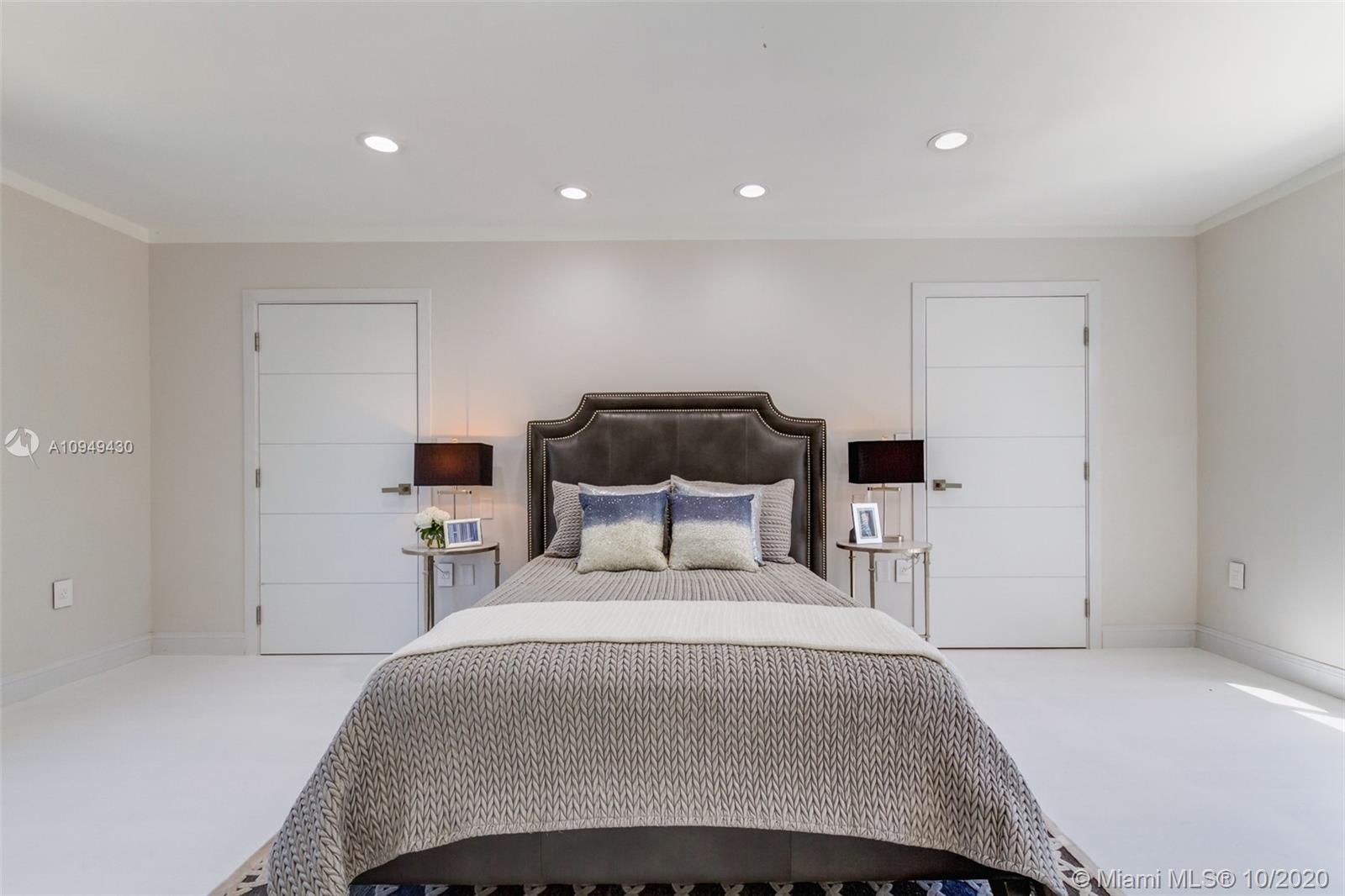 6030 Alton Road Miami Beach, FL 33140 - Photo 23 of 51 a bedroom with a bed and a night stand