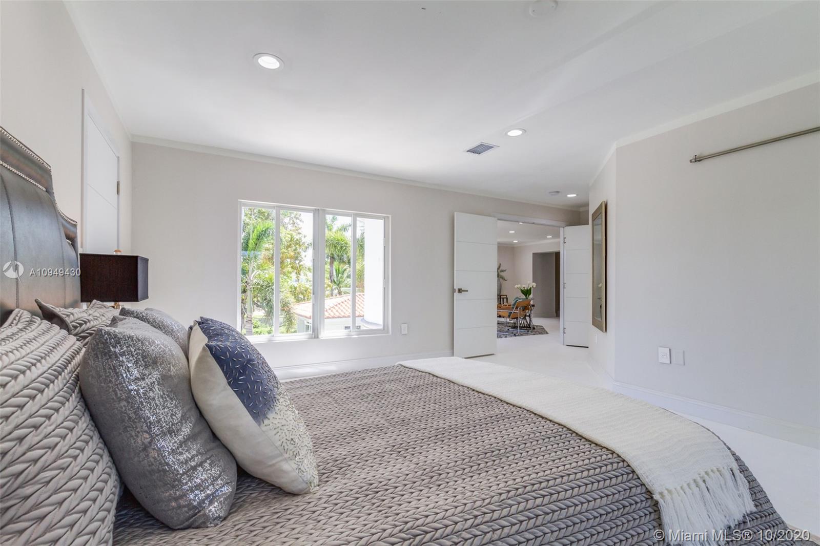 6030 Alton Road Miami Beach, FL 33140 - Photo 24 of 51 a spacious bedroom with a bed and a couch