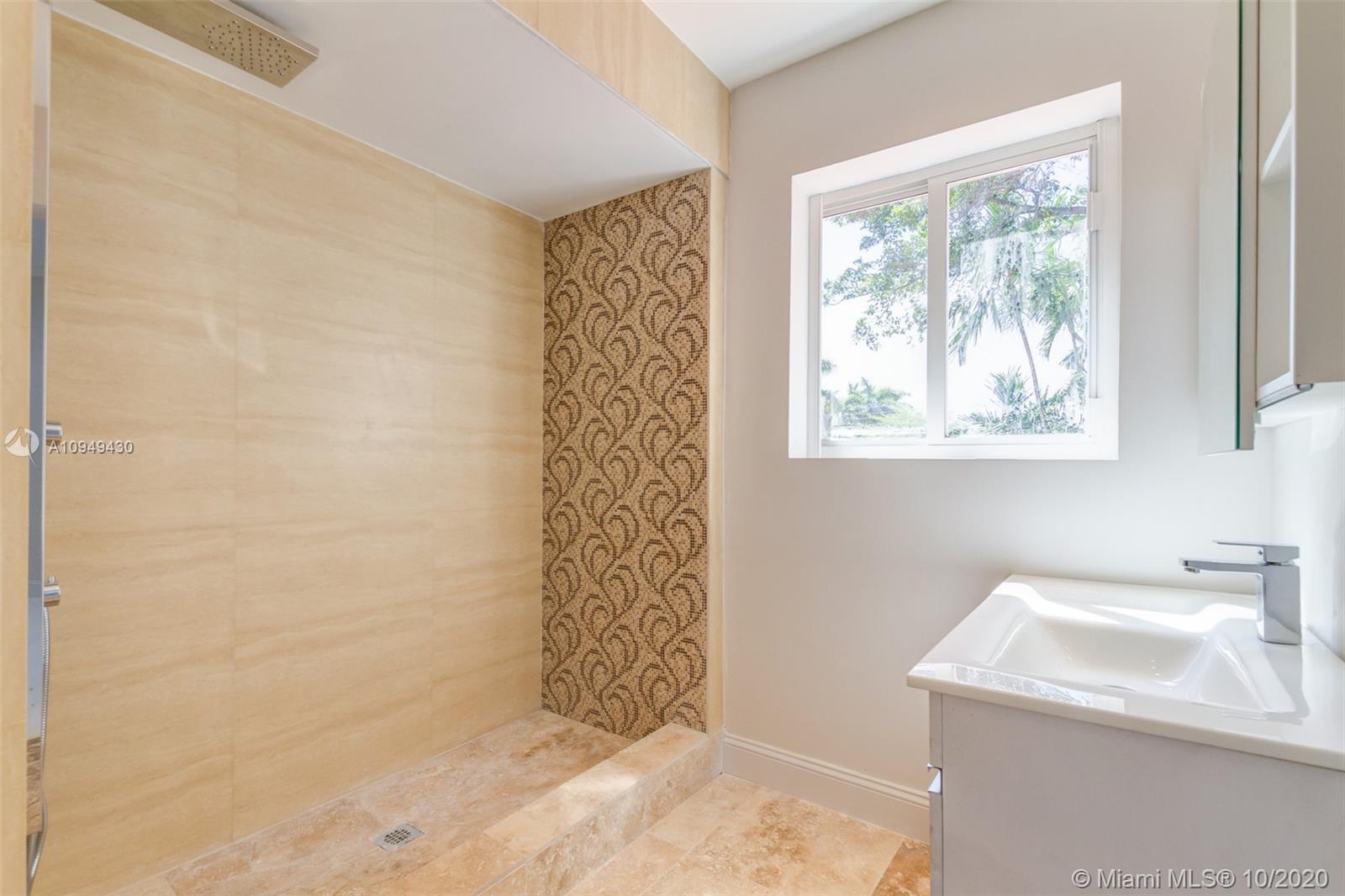 6030 Alton Road Miami Beach, FL 33140 - Photo 37 of 51 a bathroom with a sink a toilet and shower