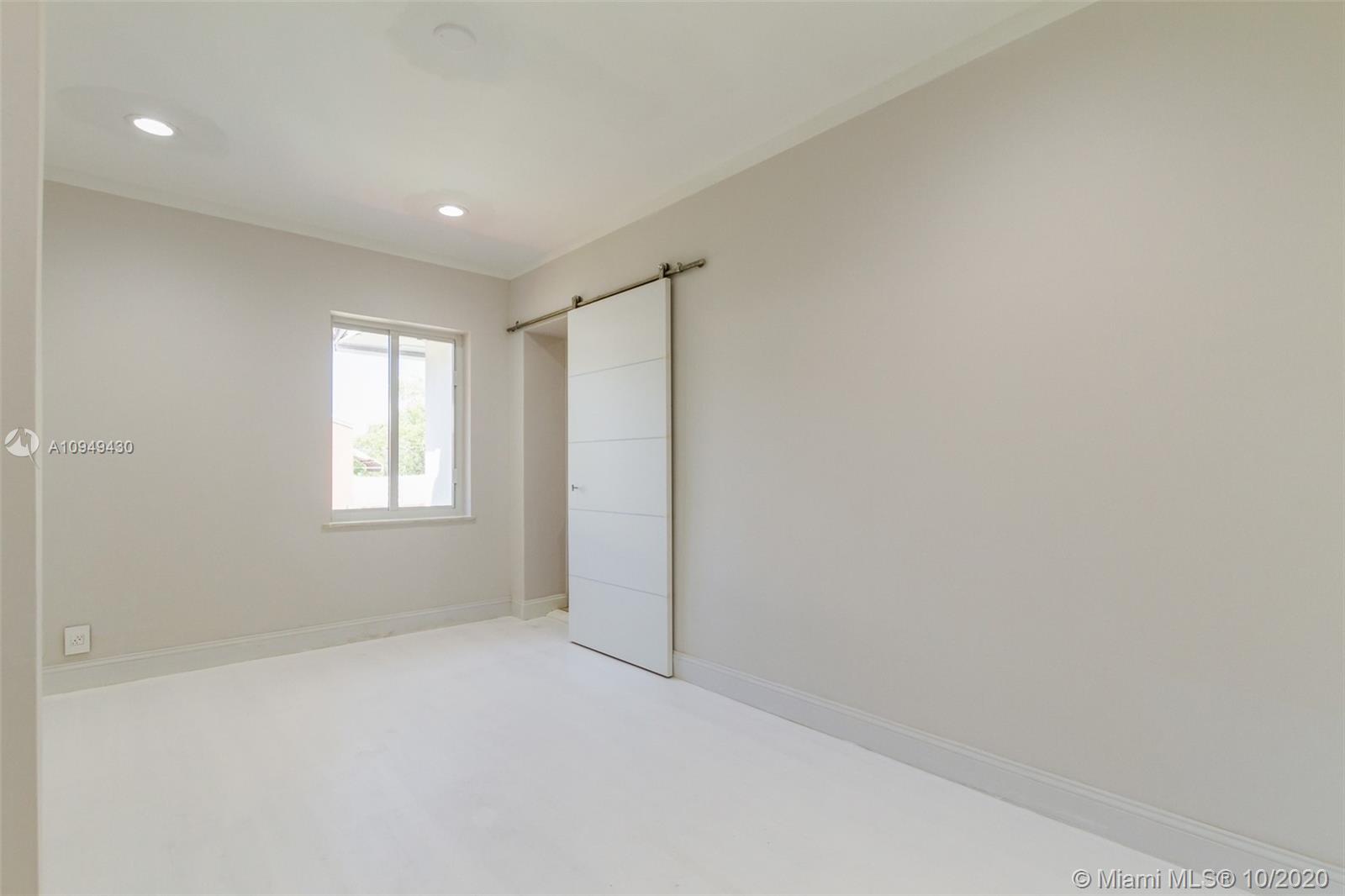 6030 Alton Road Miami Beach, FL 33140 - Photo 39 of 51 an empty room with windows and closet