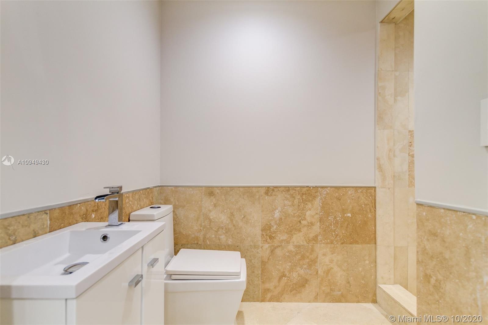 6030 Alton Road Miami Beach, FL 33140 - Photo 41 of 51 a bathroom with a sink a toilet and bathtub