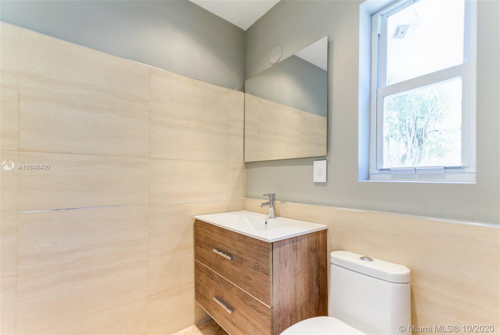 6030 Alton Road Miami Beach, FL 33140 - Photo 51 of 51 a bathroom with a sink mirror vanity and toilet