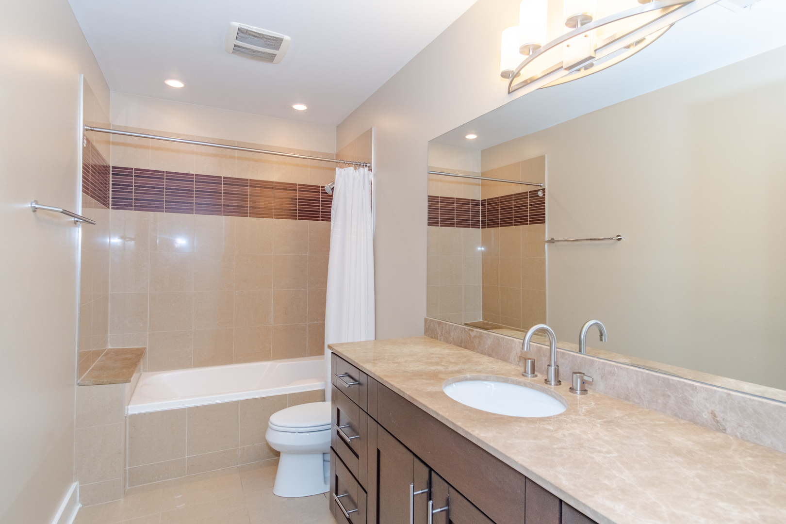 1242 West Jackson Boulevard, Unit 1W Chicago, IL 60607 - Photo 14 of 24 a bathroom with a granite countertop sink toilet and shower