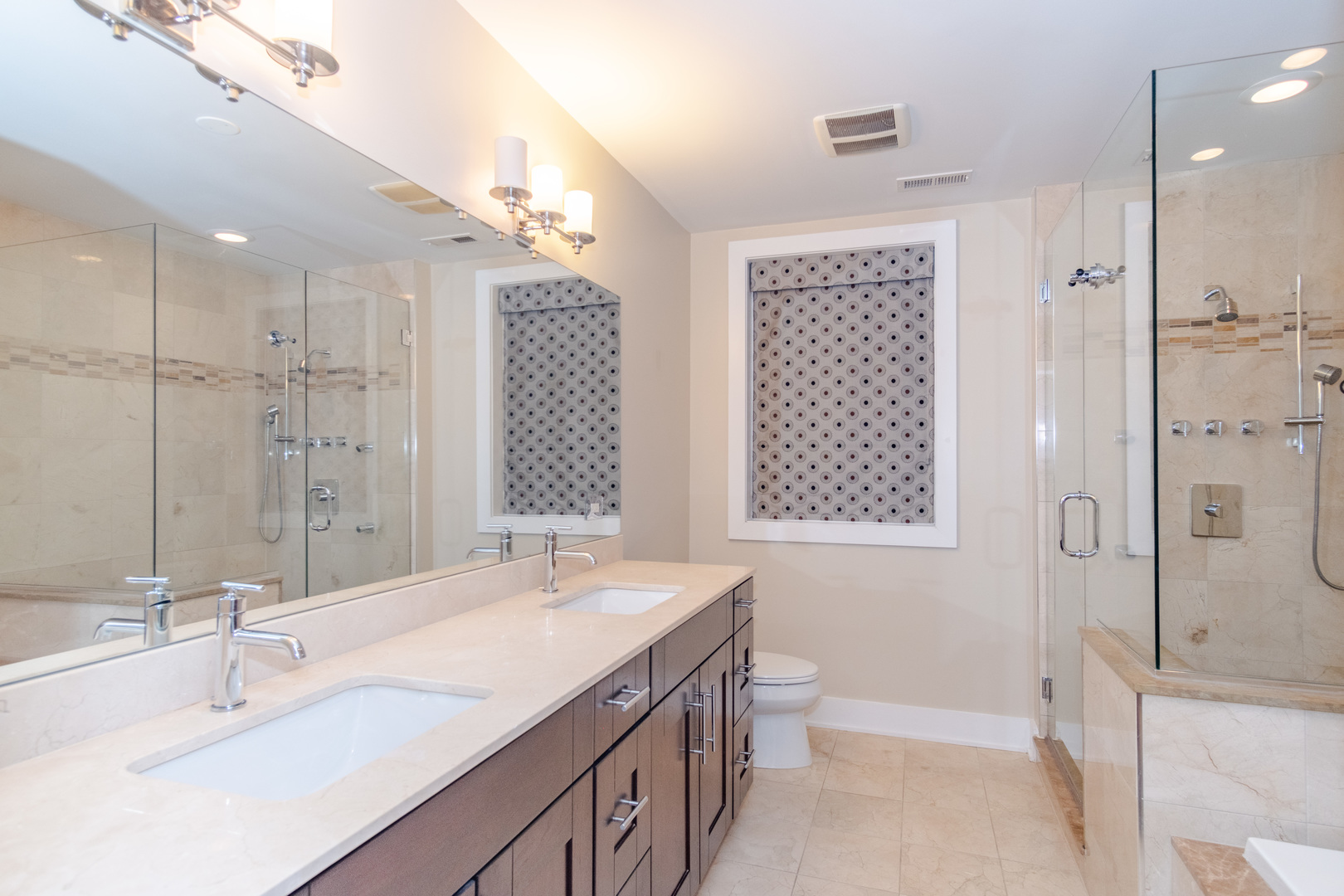 1242 West Jackson Boulevard, Unit 1W Chicago, IL 60607 - Photo 15 of 24 a bathroom with a double vanity sink mirror double and shower